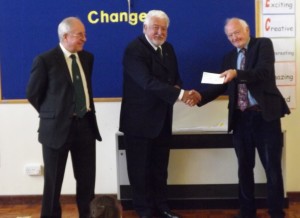 Master W.Bro. John Kemp (centre) presenting a cheque for £500 to Glynn Rowlands (right) of Woolgrove School. Watched by the Lodge Charity Steward W.Bro. John Clark (left)